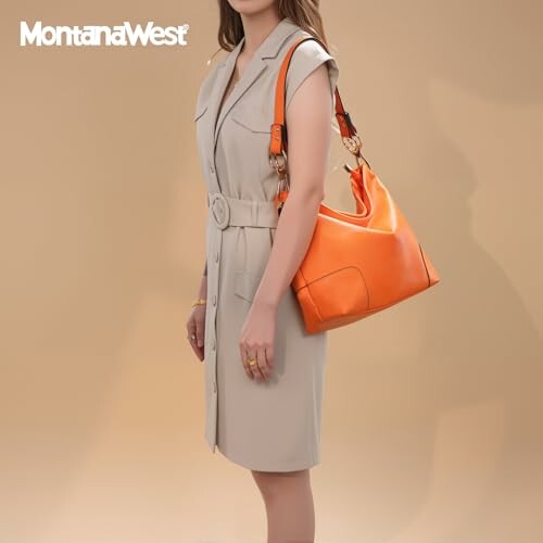 Woman in beige dress holding an orange handbag.